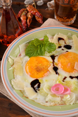 Dish with fried eggs boundary and aromas