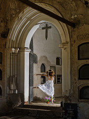 Old cemetery and a woman dancing on a grave