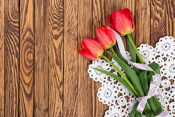 Tulips on a wooden background. Space for text. Top view