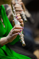 Hands of a woman playing the flute closeup © furtseff