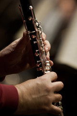 Fototapeta premium Human hands playing a clarinet closeup