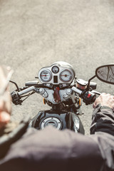 Fototapeta na wymiar Senior man steering motorcycle on road