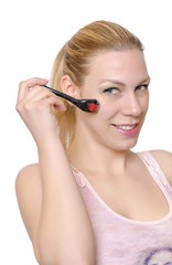 Fototapeta premium Dermaroller. Beautiful young woman performs Dermaroller procedure