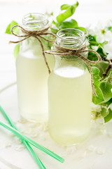 Two bottles of apple cider decorated pear blossom. Selective focus