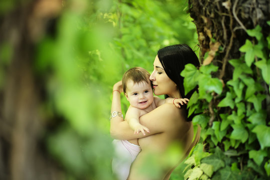 Baby and mother hugging topless