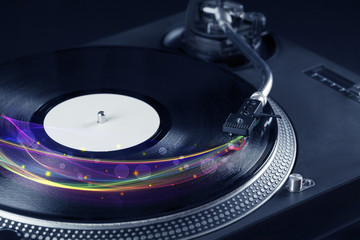Turntable playing vinyl with glowing abstract lines