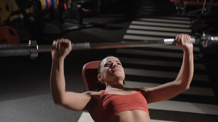 Young woman making exercise at the gym