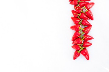 Group of fresh red hot chilli peppers on a white background. Healthy food. Fresh vegetables. Space on left side.