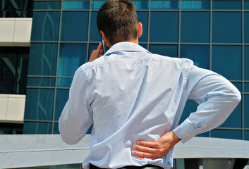 Man with  back pain. Business man rubbing his painful low back