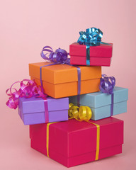 colorful present boxes with ribbon stacked asymmetrically