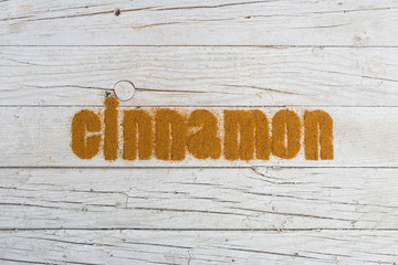 Cinnamon word written with ground cinnamon