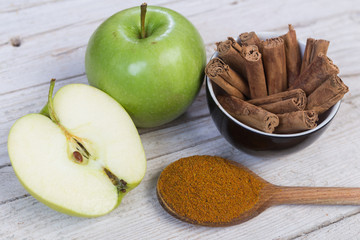 Cinnamon on a spoon with apples