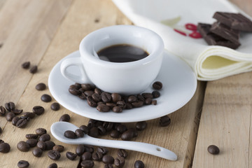 hot espresso coffee in a white cup served on an old wooden table.