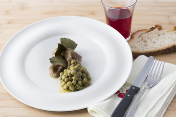 beef stew with peas served on a white plate