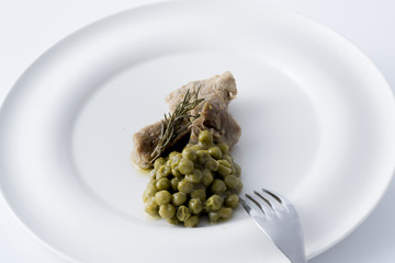 beef stew with peas served on a white plate
