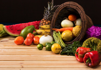 basket and table full of colorful fruits and vegetables