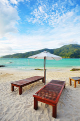 Beach chair and umbrella on sand beach