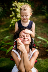 Happy family. Young beautiful mother and her daughter having fun on the beach. Positive human emotions, feelings. 