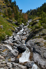 High mountain stream flowing between the rocks