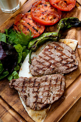 Club Beef steak with pepper sauce and Grilled vegetables on cutting board on wooden background