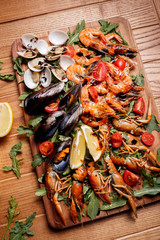 Fresh mussels, crayfish, shrimp decorated with arugula, tomatoes