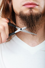 Man cutting his beard