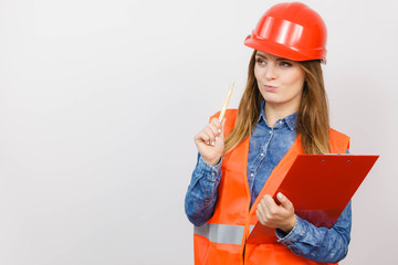 Woman engineer construction builder in helmet.