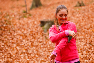 Sporty girl rest in forest listening music.