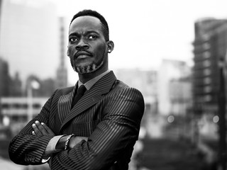 African businessman portrait with crossed arms in the city monochrome