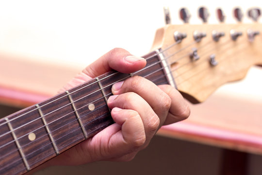 Close up of an electric guitar being played