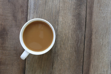 White coffee cup placed on the old wooden floor.