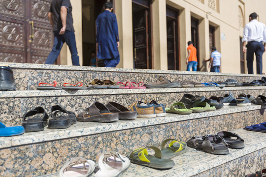 Sandals outside a mosque during prayer time in Dubai.