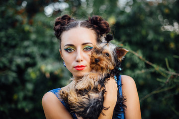 Young beautiful woman with Yorkshire Terrier