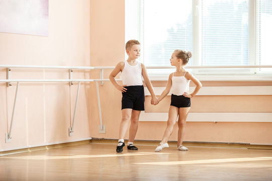Young boy and a girl dancing at ballet class 