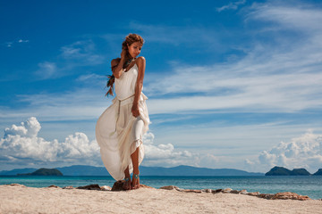 Fototapeta na wymiar beautiful young bride on the beach