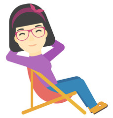Fototapeta premium Woman sitting in a folding chair.