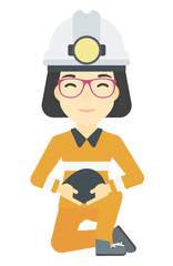 Miner holding coal in hands.