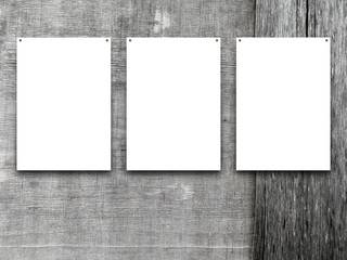 Close-up of three nailed blank frames on grey weathered wooden boards background