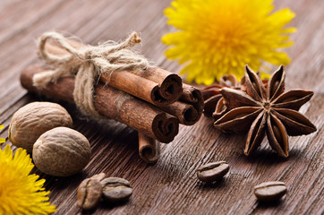 spices from coffee beans and flowers on the wooden background