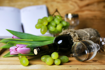 wine bottle book and glass grape