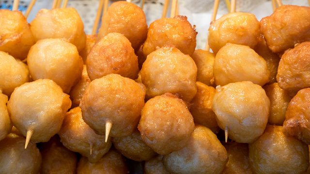 The close up of Taiwanese fried fish balls on stick at food street market in Taipei, Taiwan.