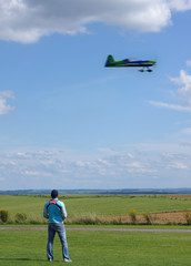 Model aircraft and its pilot in a beautiful landscape