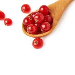 Wooden spoon filled with Red Currant isolated over white background