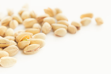The pistachios on white background. The pistachio background.