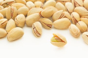 The pistachios on white background. The pistachio background.