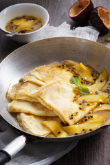 crepes with passion and mango syrup