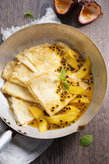 crepes with passion and mango syrup