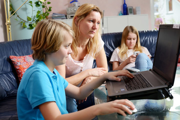 mother and her children using computer