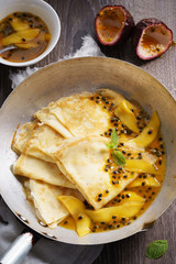 crepes with passion and mango syrup