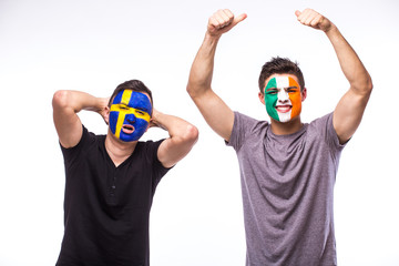 Sweden vs Republic of Ireland. Football fans of national teams demonstrate emotions: Sweden lose, Republic of Ireland win. European football fans concept.